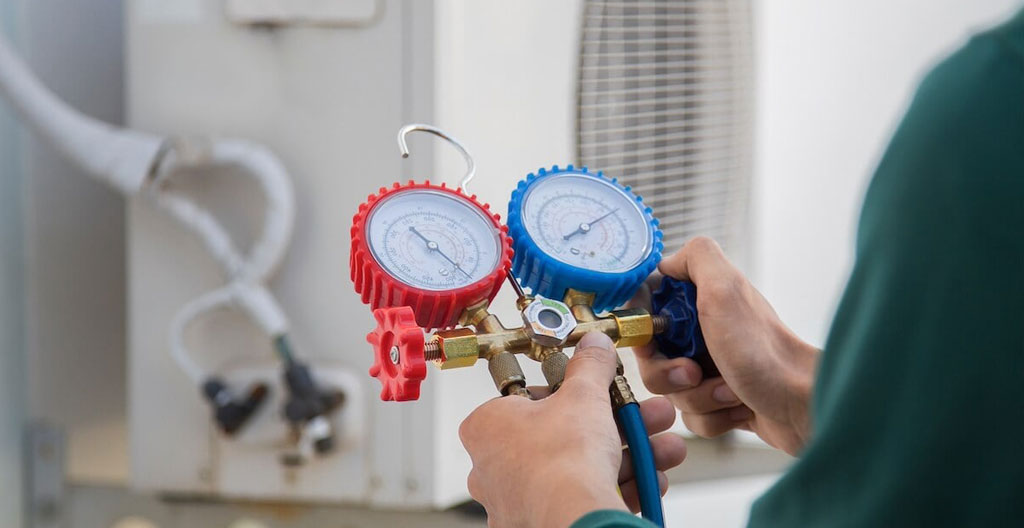 Sphère transparente représentant la Terre entourée de particules rouges et vertes, symbolisant l'impact des fluides frigorigènes sur le climat.
